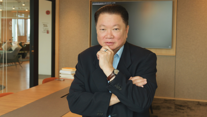 Tai Pham seated in the BKSAI office